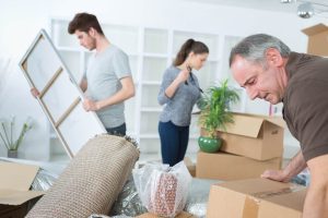 Family packing household items into boxes.